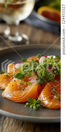 Thinly sliced salmon carpaccio appetizer garnished with fresh microgreens, sesame seeds, and a drizzle of olive oil Thinly sliced salmon carpaccio appetizer garnished with fresh microgreens, sesame seeds, and a drizzle of olive oil 124453327