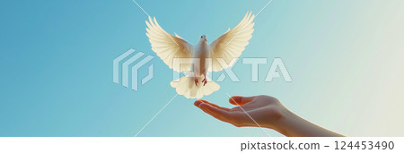 Woman releasing white dove into clear blue sky, symbolizing peace, freedom and hope 124453490