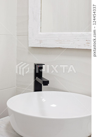 Modern black faucet, empty sink and white ceramic tiles Modern black faucet, empty sink and white ceramic tiles 124454337