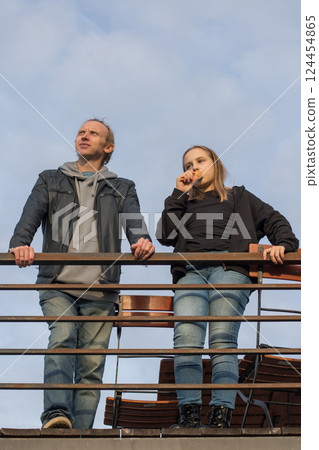 Happy childhood and weekend concept. Young girl daughter and her father standing Happy childhood and weekend concept. Young girl daughter and her father standing 124454865