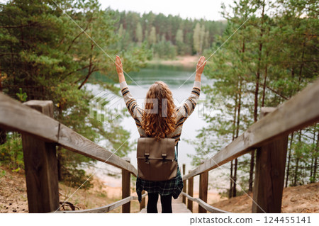 Attractive young woman enjoying fresh air on the lake. Travel, Hiking, nature Attractive young woman enjoying fresh air on the lake. Travel, Hiking, nature 124455141