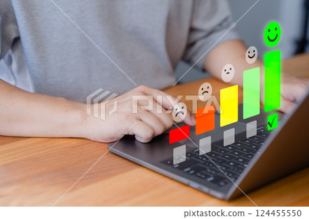 Customer using a laptop select a happy face icon from a feedback scale with five emoji option, symbolizing customer satisfaction, review, and positive user experience in an online feedback system. Customer using a laptop select a happy face icon from a feedback scale with five emoji option, symbolizing customer satisfaction, review, and positive user experience in an online feedback system. 124455550