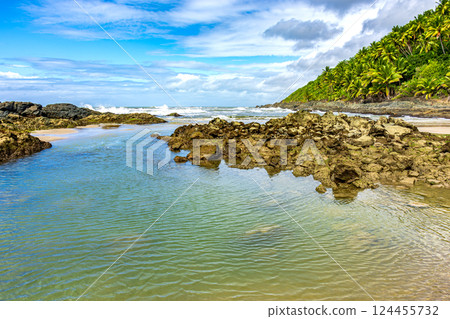 Rocks and water on a deserted beach Rocks and water on a deserted beach 124455732