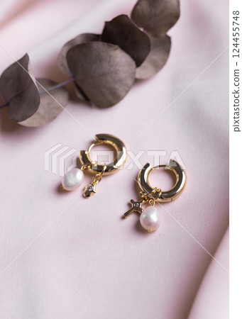 Silver earrings made of natural pearl. Natural mineral texture jewellery. Bijouterie and handmade accessories top view elegant background Silver earrings made of natural pearl. Natural mineral texture jewellery. Bijouterie and handmade accessories top view elegant background 124455748