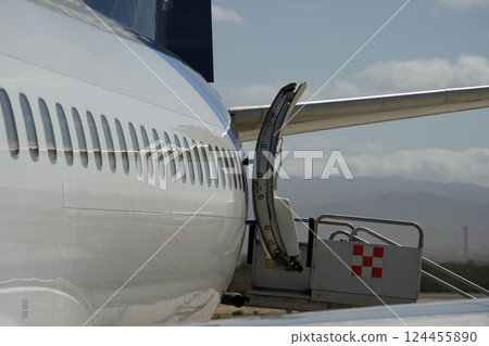 airplane detail of cabin windows and fuselage 124455890