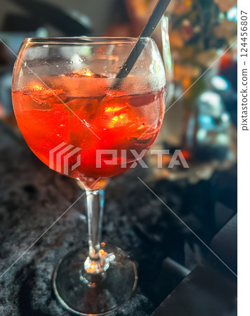 Cocktail with orange and ice in a glass on the table Cocktail with orange and ice in a glass on the table 124456807