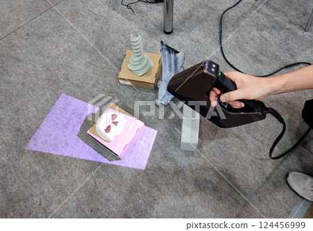 3D scanning. Working portable 3D scanner. Man scanning an object with a portable 3D scanner. Manual 3D scanning different models. New modern digitization technologies 124456999