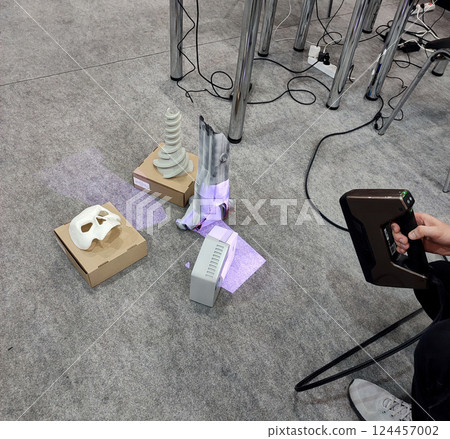 3D scanning. Working portable 3D scanner. Man scanning an object with a portable 3D scanner. Manual 3D scanning different models. New modern digitization technologies 124457002