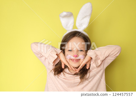 A playful girl dressed up as an Easter bunny shows off her makeup A playful girl dressed up as an Easter bunny shows off her makeup 124457557