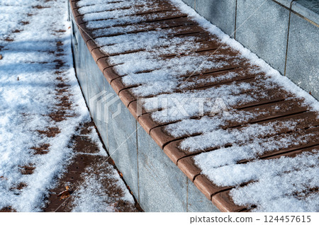 Snow piled bench 124457615