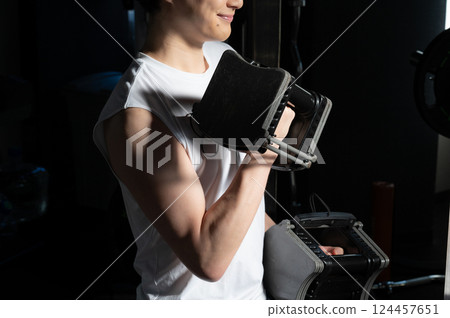 Man doing muscle training with dumbbells Man doing muscle training with dumbbells 124457651