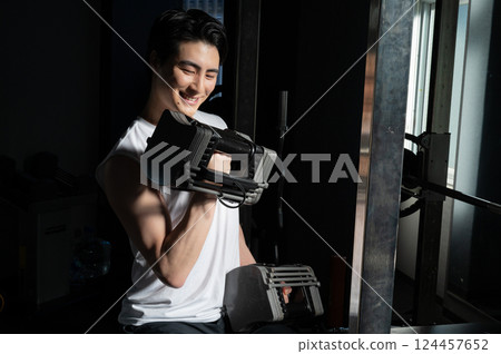 Man doing muscle training with dumbbells 124457652