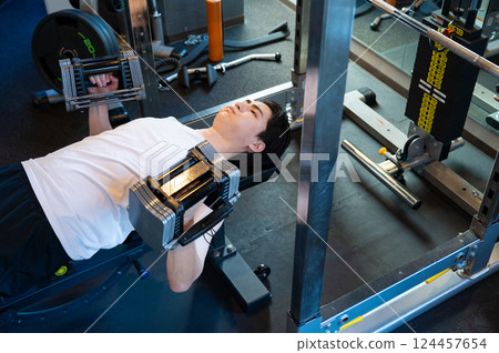 Man doing muscle training with dumbbells Man doing muscle training with dumbbells 124457654