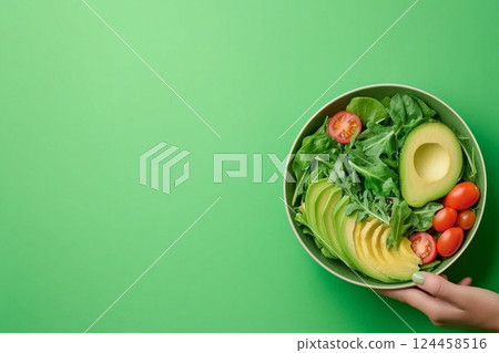 Fresh salad bowl with mixed greens, avocado, and cherry tomatoes for healthy eating 124458516