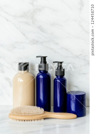 Elegant skincare set with navy blue bottles and natural-bristle brush for premium self-care routine 124458710
