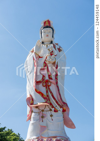 Guanyin statue, the Goddess of Mercy, against the blue sky. At Wat Saman Rattanaram, Chachoengsao , Thailand Guanyin statue, the Goddess of Mercy, against the blue sky. At Wat Saman Rattanaram, Chachoengsao , Thailand 124459148