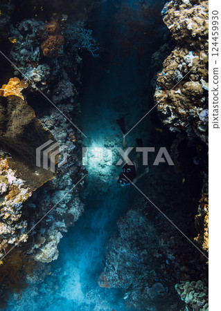 Woman free diver dives in underwater cave, extreme free diving 124459930