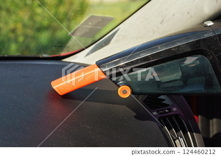 Car dashboard cleaned from dust with small orange portable vacuum cleaner Car dashboard cleaned from dust with small orange portable vacuum cleaner 124460212