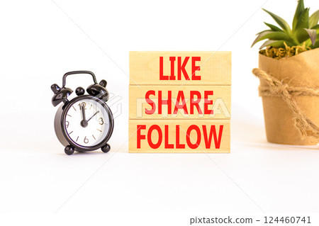 Like share follow symbol. Concept words Like Share Follow on beautiful wooden blocks. Beautiful white background. Black alarm clock. Business like share follow concept. Copy space. 124460741