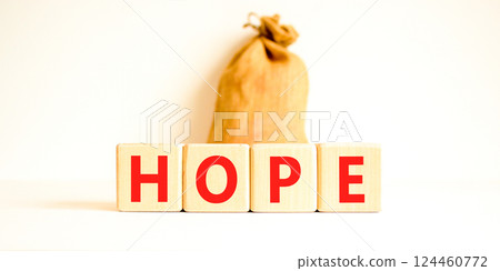 Hope symbol. Concept word Hope on beautiful wooden blocks. Beautiful canvas bag. Beautiful white table white background. Business, lifestyle, support and hope concept. Copy space. 124460772
