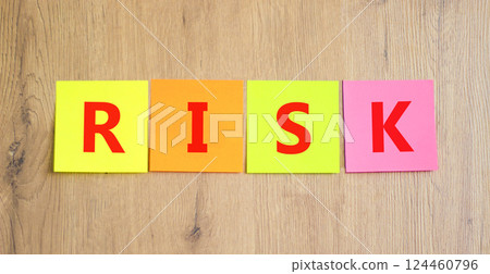 Risk symbol. Concept word Risk on beautiful colored paper. Beautiful wooden table wooden background. Business, lifestyle, support and risk concept. Copy space. 124460796