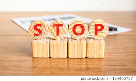 Stop symbol. Concept word Stop on beautiful wooden circles on wooden blocks. Beautiful wooden table white background. Business, lifestyle, support and stop concept. Copy space. 124460797