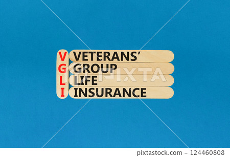VGLI Veterans Group Life Insurance symbol. Concept word VGLI Veterans Group Life Insurance on sticks. Beautiful blue background. Business VGLI Veterans Group Life Insurance concept. Copy space. 124460808