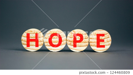 Hope symbol. Concept word Hope on beautiful wooden circles. Beautiful grey table grey background. Business, lifestyle, support and hope concept. Copy space. 124460809
