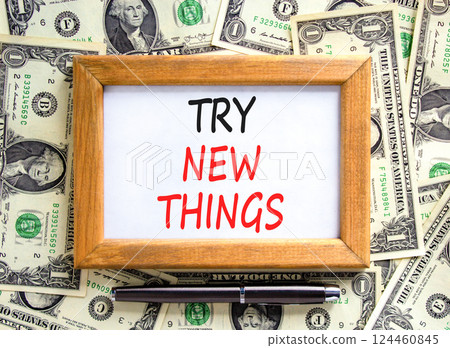 Try new things symbol. Concept words Try new things on beautiful picture frame. Black pen. Beautiful background from dollar bills. Business motivational lifestyle try new things concept. Copy space. 124460845
