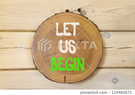 Let us begin symbol. Concept words Let us begin on beautiful wooden circle. Beautiful wooden wall wooden background. Business motivational let us begin concept. Copy space. 124460875