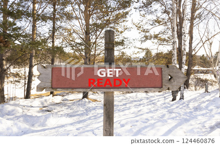 Get ready symbol. Concept words Get ready on beautiful wooden road sign. Beautiful forest snow blue sky background. Business, support, motivation and get ready concept. Copy space. 124460876