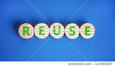 Reuse symbol. Concept word Reuse on beautiful wooden circles. Beautiful blue table blue background. Business lifestyle ecological reuse concept. Copy space. Reuse symbol. Concept word Reuse on beautiful wooden circles. Beautiful blue table blue background. Business lifestyle ecological reuse concept. Copy space. 124460887