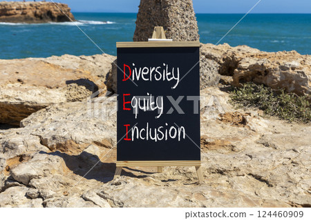 DEI diversity equity and inclusion symbol. Concept words DEI diversity equity inclusion on blackboard. Beautiful stone sea background. Business DEI diversity equity and inclusion concept. Copy space. DEI diversity equity and inclusion symbol. Concept words DEI diversity equity inclusion on blackboard. Beautiful stone sea background. Business DEI diversity equity and inclusion concept. Copy space. 124460909