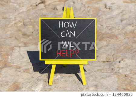 How can we help symbol. Concept words How can we help on beautiful black blackboard. Beautiful stone background. Business and how can we help concept. Copy space. 124460923