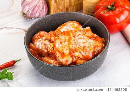 Raw marinated uncooked chicken wings 124462208