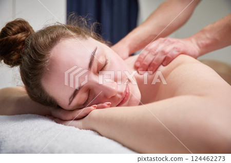 Beautiful young girl relaxing with hand massage at spa during a beauty treatment Beautiful young girl relaxing with hand massage at spa during a beauty treatment 124462273