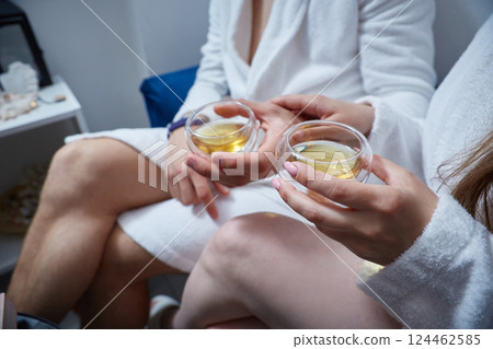 Faceless man and woman enjoy a drink at the spa 124462585