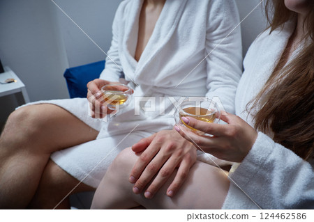 Faceless man and woman enjoy a drink at the spa Faceless man and woman enjoy a drink at the spa 124462586