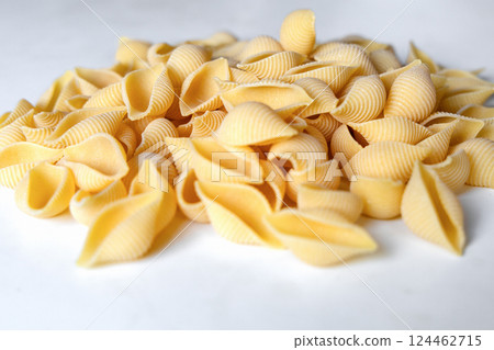 Uncooked dried conchiglie. Pile of shell pasta 124462715