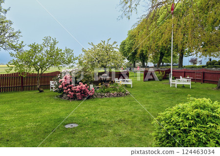 Summer garden with flowers and green lawn Summer garden with flowers and green lawn 124463034