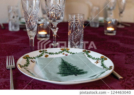 Set Christmas table with Christmas plate and crystal glasses. Set Christmas table with Christmas plate and crystal glasses. 124463040