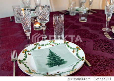 Set Christmas table with Christmas plate and crystal glasses. Set Christmas table with Christmas plate and crystal glasses. 124463041