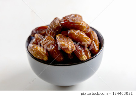 Delicious dates in a bowl on white 124463051
