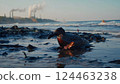 A seabird covered in thick black oil struggling to move on a polluted shoreline, its feathers drenched and sticky, with a dark, oily ocean in the background 124463238
