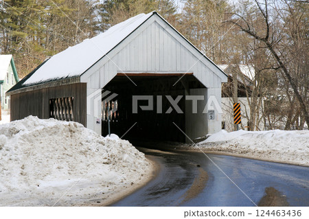 Snow-covered Bridge With a Winding Road in Winter Scenery in Vermont 124463436