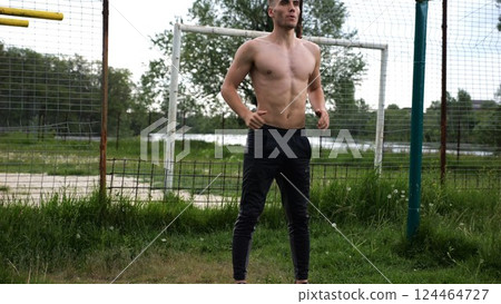 Male shirtless athlete doing squats at sports ground. Young sportsman working at summer nature. Strong sporty man exercising outdoor. Concept of active and sportive lifestyle. Slow motion 124464727