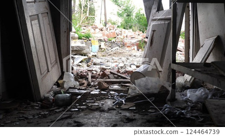View to destroyed residential buildings at Kharkivska oblast. Ruined houses after bomb attacks on ukrainian territory from russia army. Consequences of russian invasion of Ukraine. Slow motion View to destroyed residential buildings at Kharkivska oblast. Ruined houses after bomb attacks on ukrainian territory from russia army. Consequences of russian invasion of Ukraine. Slow motion 124464739