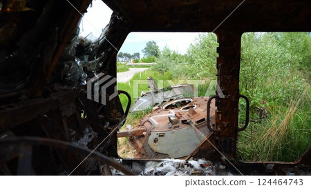 Rusty and burned-out armored vehicles on ukrainian territory. Exhibition of destroyed military equipment of the russian army. War between Ukraine and russia. Close up Slow motion 124464743