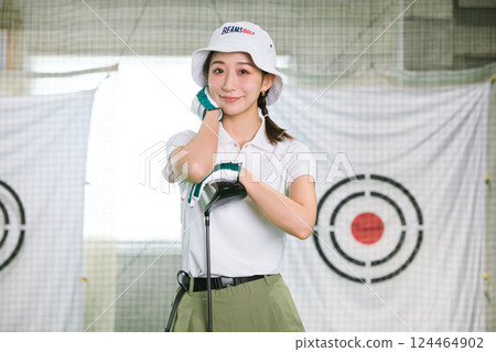 一名女子在室內高爾夫練習場練習 124464902