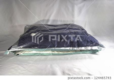 Clothes and bedding packed in compression bags 124465743